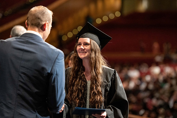 Graduates walk across the stage at the BYU-Idaho Center as they accept their diplomas for Agriculture and Life Science.