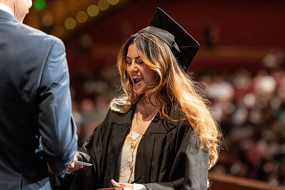 Graduates walk across the stage at the BYU-Idaho Center as they accept their diplomas for Agriculture and Life Science.