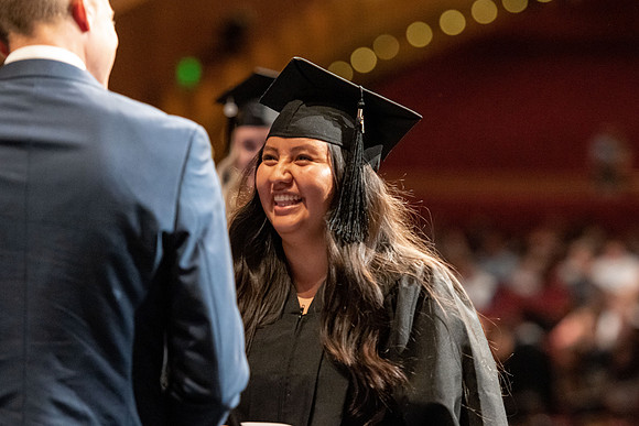 Graduates walk across the stage at the BYU-Idaho Center as they accept their diplomas for Agriculture and Life Science.