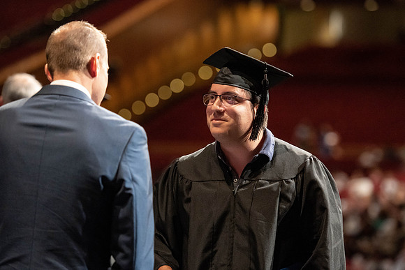 Graduates walk across the stage at the BYU-Idaho Center as they accept their diplomas for Agriculture and Life Science.