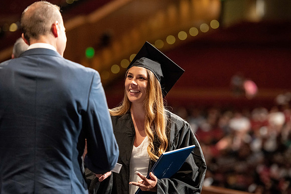 Graduates walk across the stage at the BYU-Idaho Center as they accept their diplomas for Agriculture and Life Science.