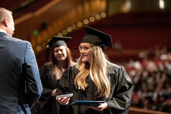 Graduates walk across the stage at the BYU-Idaho Center as they accept their diplomas for Agriculture and Life Science.