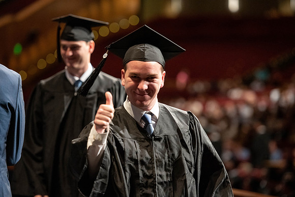 Graduates walk across the stage at the BYU-Idaho Center as they accept their diplomas for Agriculture and Life Science.