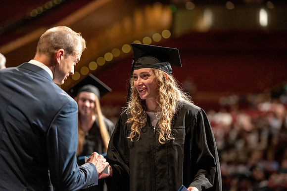 Graduates walk across the stage at the BYU-Idaho Center as they accept their diplomas for Agriculture and Life Science.