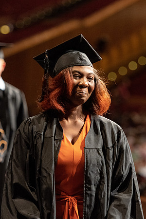 Graduates walk across the stage at the BYU-Idaho Center as they accept their diplomas for Agriculture and Life Science.