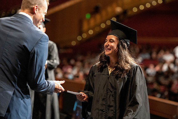 Graduates walk across the stage at the BYU-Idaho Center as they accept their diplomas for Agriculture and Life Science.