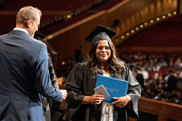 Graduates walk across the stage at the BYU-Idaho Center as they accept their diplomas for Agriculture and Life Science.