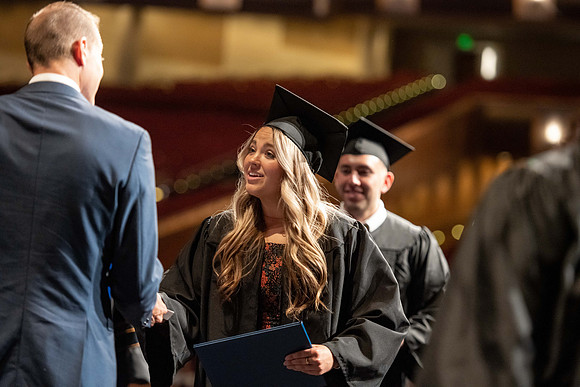 Graduates walk across the stage at the BYU-Idaho Center as they accept their diplomas for Agriculture and Life Science.