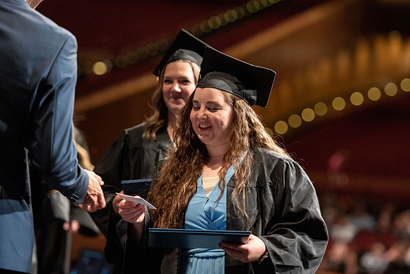 Graduates walk across the stage at the BYU-Idaho Center as they accept their diplomas for Agriculture and Life Science.