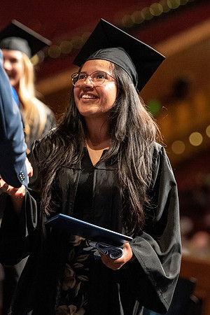 Graduates walk across the stage at the BYU-Idaho Center as they accept their diplomas for Agriculture and Life Science.