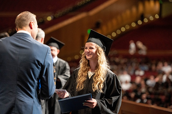 Graduates walk across the stage at the BYU-Idaho Center as they accept their diplomas for Agriculture and Life Science.