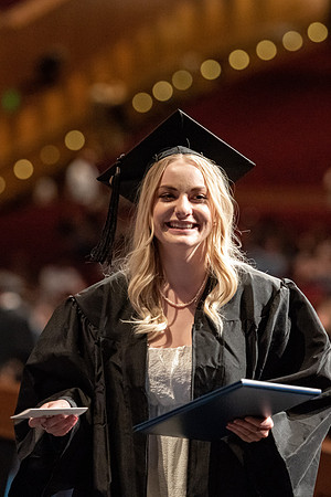 Graduates walk across the stage at the BYU-Idaho Center as they accept their diplomas for Agriculture and Life Science.