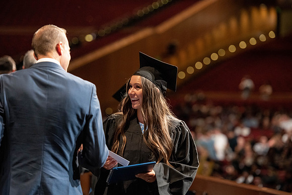 Graduates walk across the stage at the BYU-Idaho Center as they accept their diplomas for Agriculture and Life Science.