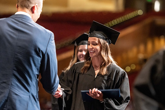 Graduates walk across the stage at the BYU-Idaho Center as they accept their diplomas for Agriculture and Life Science.