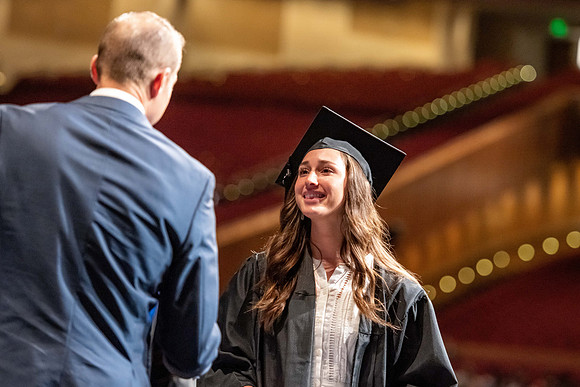 Graduates walk across the stage at the BYU-Idaho Center as they accept their diplomas for Agriculture and Life Science.