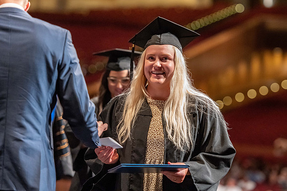 Graduates walk across the stage at the BYU-Idaho Center as they accept their diplomas for Agriculture and Life Science.