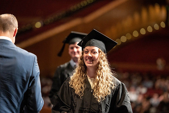 Graduates walk across the stage at the BYU-Idaho Center as they accept their diplomas for Agriculture and Life Science.