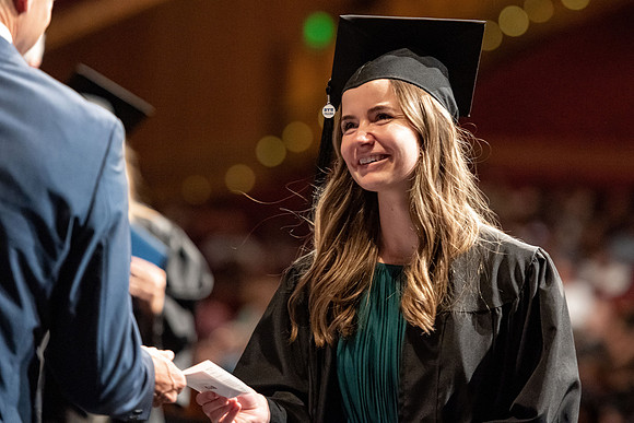 Graduates walk across the stage at the BYU-Idaho Center as they accept their diplomas for Agriculture and Life Science.