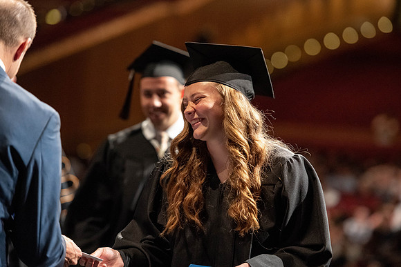 Graduates walk across the stage at the BYU-Idaho Center as they accept their diplomas for Agriculture and Life Science.