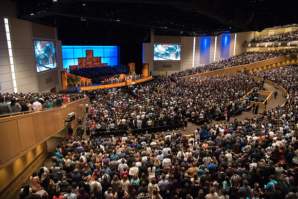 The congregation stands as Elder Dallin H. Oaks, of the Quorum of the Twelve, enters for Devotional.