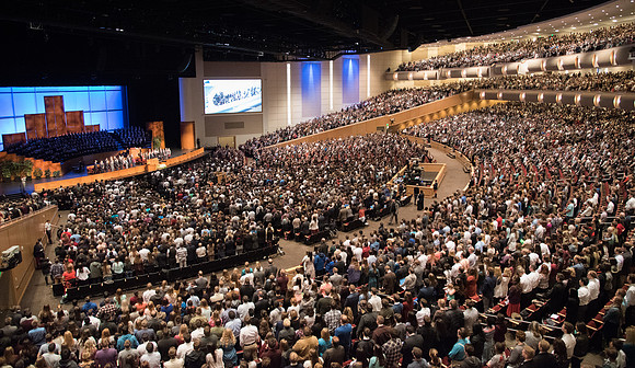 The congregation stands as Elder Dallin H. Oaks, of the Quorum of the Twelve, enters for Devotional.