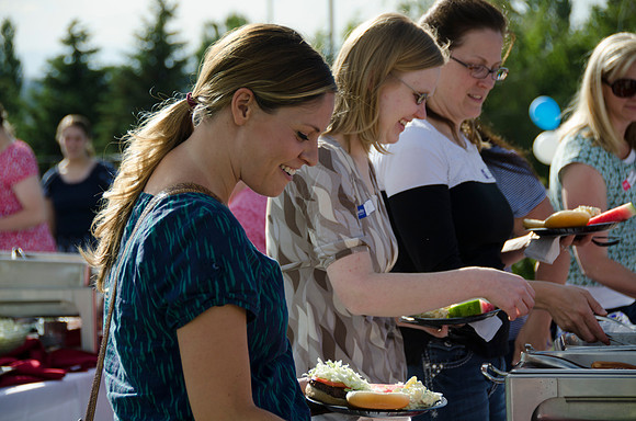 Online instructors gather with their families for an eveing of BBQ and games.