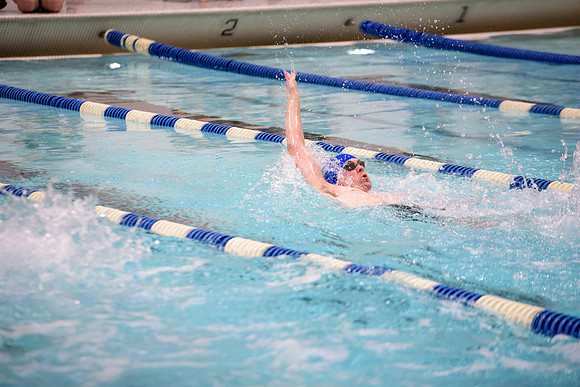 Students of varying swim teams compete in different swimming events.