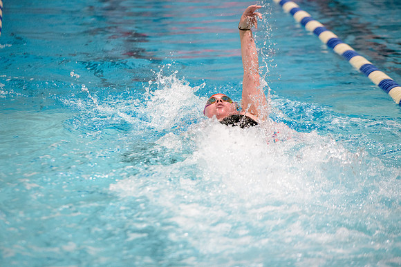 Students of varying swim teams compete in different swimming events.