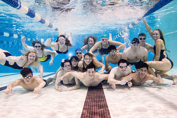 The Knights swim team pose together for a photo during practice.