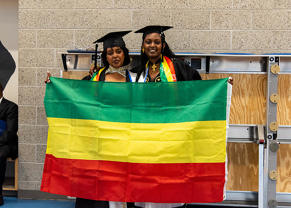 Students before commencement, talking with family and friends.