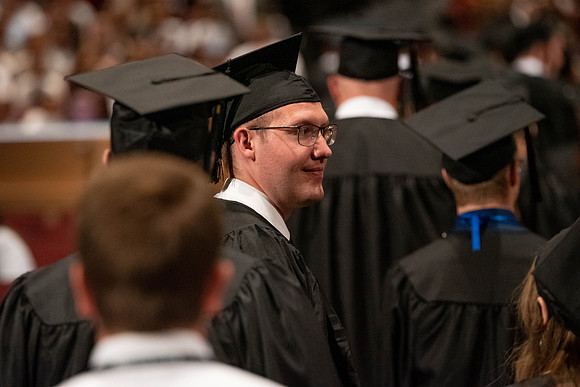 Students during commencement, walking.