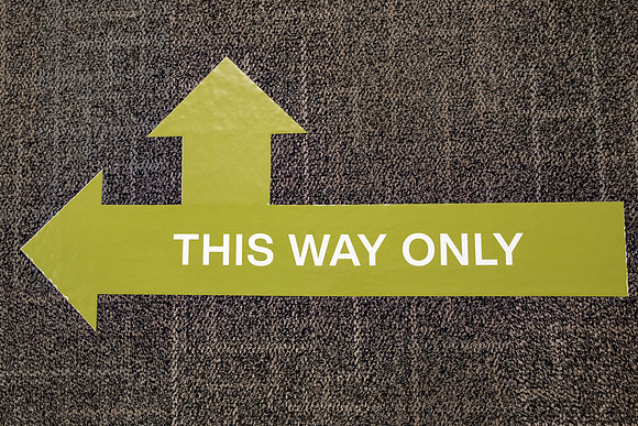 Stickers in the Taylor Building showing which way to walk down the hallways. The stickers are to direct foot traffic through buildings to try to help fight the virus, COVID-19, on campus.