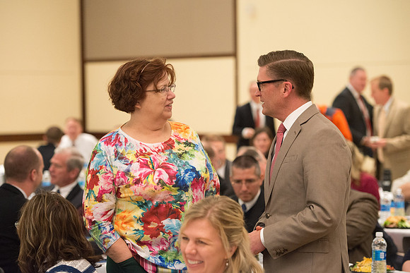 Faculty gather at a luncheon to be taught by Clayton Christensen, the "Kim B. Clark Professor" of Business Administration at the Harvard Business School.