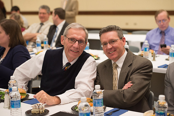 Faculty gather at a luncheon to be taught by Clayton Christensen, the "Kim B. Clark Professor" of Business Administration at the Harvard Business School.