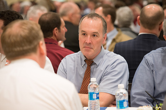 Faculty gather at a luncheon to be taught by Clayton Christensen, the "Kim B. Clark Professor" of Business Administration at the Harvard Business School.