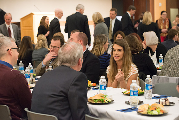 Faculty gather at a luncheon to be taught by Clayton Christensen, the "Kim B. Clark Professor" of Business Administration at the Harvard Business School.