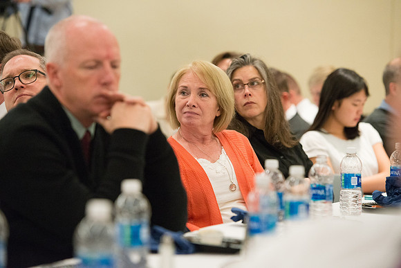 Faculty gather at a luncheon to be taught by Clayton Christensen, the "Kim B. Clark Professor" of Business Administration at the Harvard Business School.