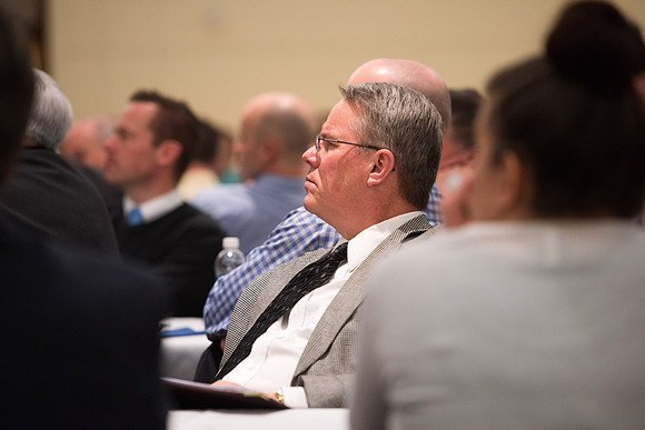 Faculty gather at a luncheon to be taught by Clayton Christensen, the "Kim B. Clark Professor" of Business Administration at the Harvard Business School.