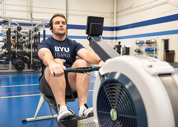 A student using the rowing machine at the Hart Fitness Center.