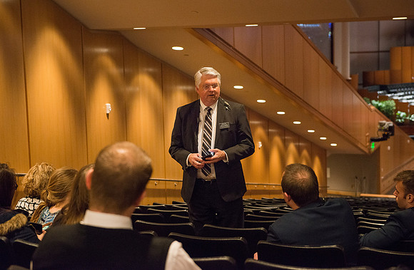 Ushers welcome students before devotional.