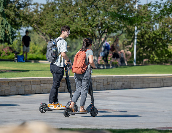 Students ride to class on electric scooters
