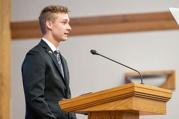 A student reads the scripture for devotional.
