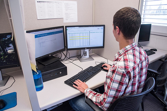 Employees work on developing a better curriculum for online students.