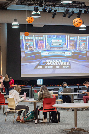 BYUI students study in the Crossroads while March Madness basketball games play.