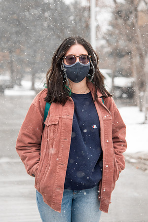 BYUI students walk around campus as it snows and rains.