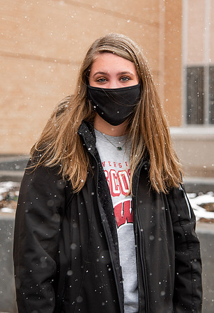 BYUI students walk around campus as it snows and rains.