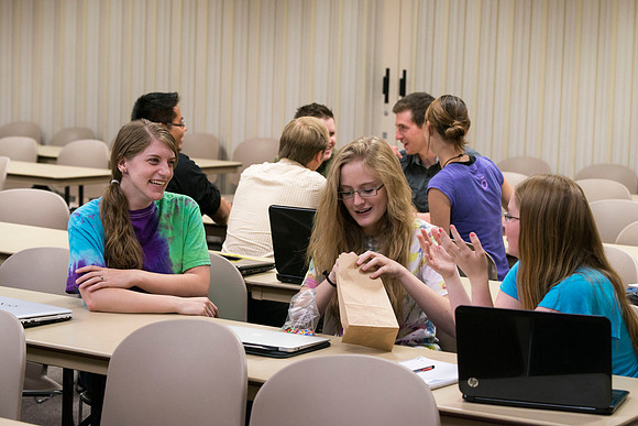 Political Science students in Brother Adamson's class interact with each other as they participate in a hands-on-activity during class.