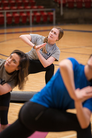 Students participate in Yoga in the Hart Auditorium.