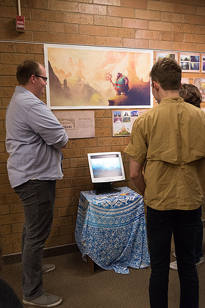 Cody Harder presents his illustration project to inquiring students.