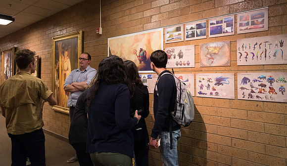 Cody Harder presents his illustration project to inquiring students.
